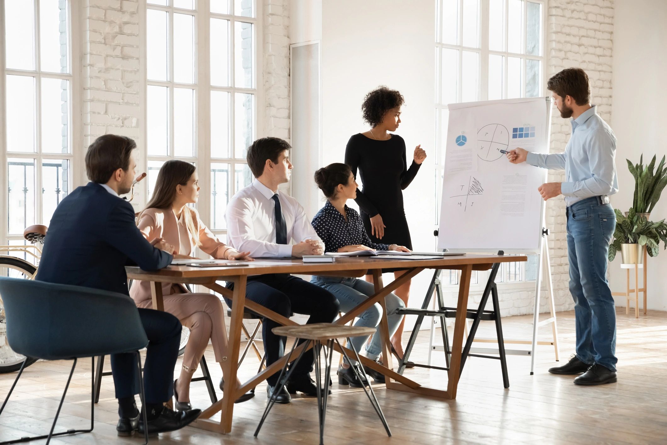 Presenters explaining data and strategy during a professional training session
