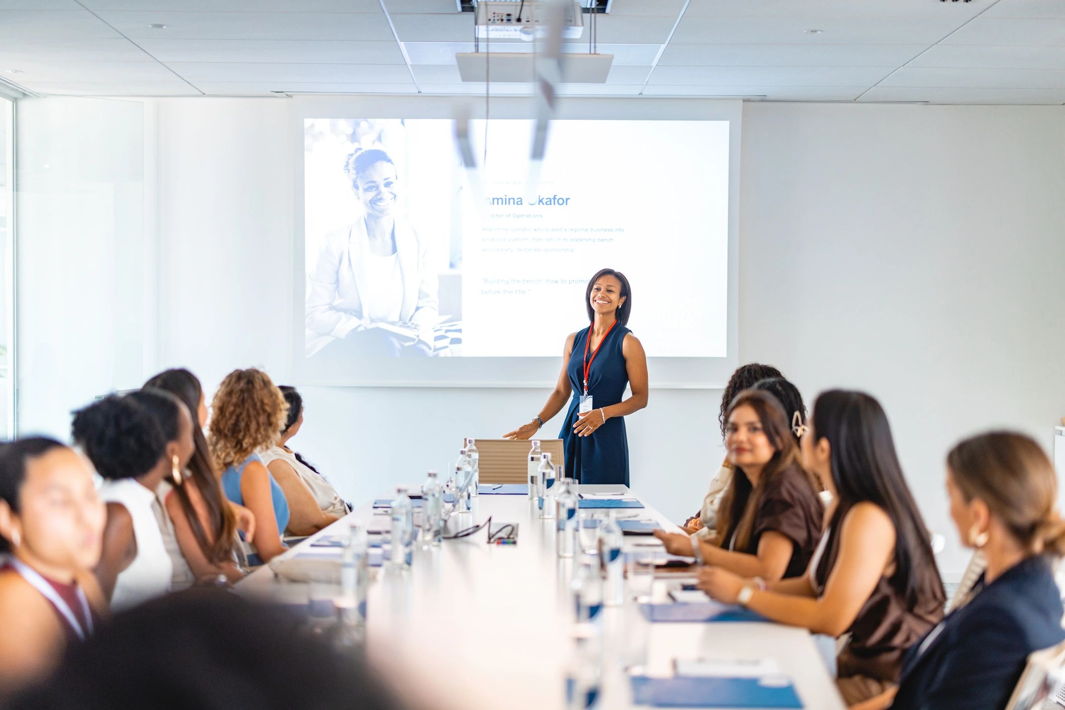 Workshop facilitator leading a seminar in a bright boardroom